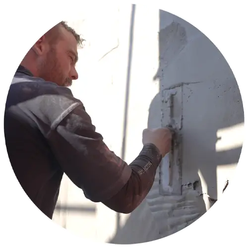Builder plastering a wall