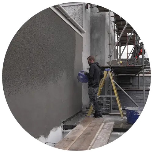Builder installing weatherproof render to exterior wall